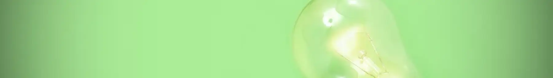 single screw fit glowing lightbulb on a green background (1)