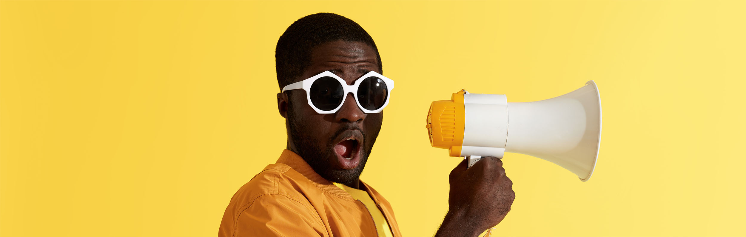 Man In Yellow With Megaphone Web