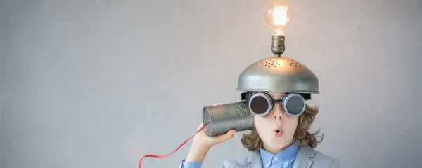 child with tin can and string