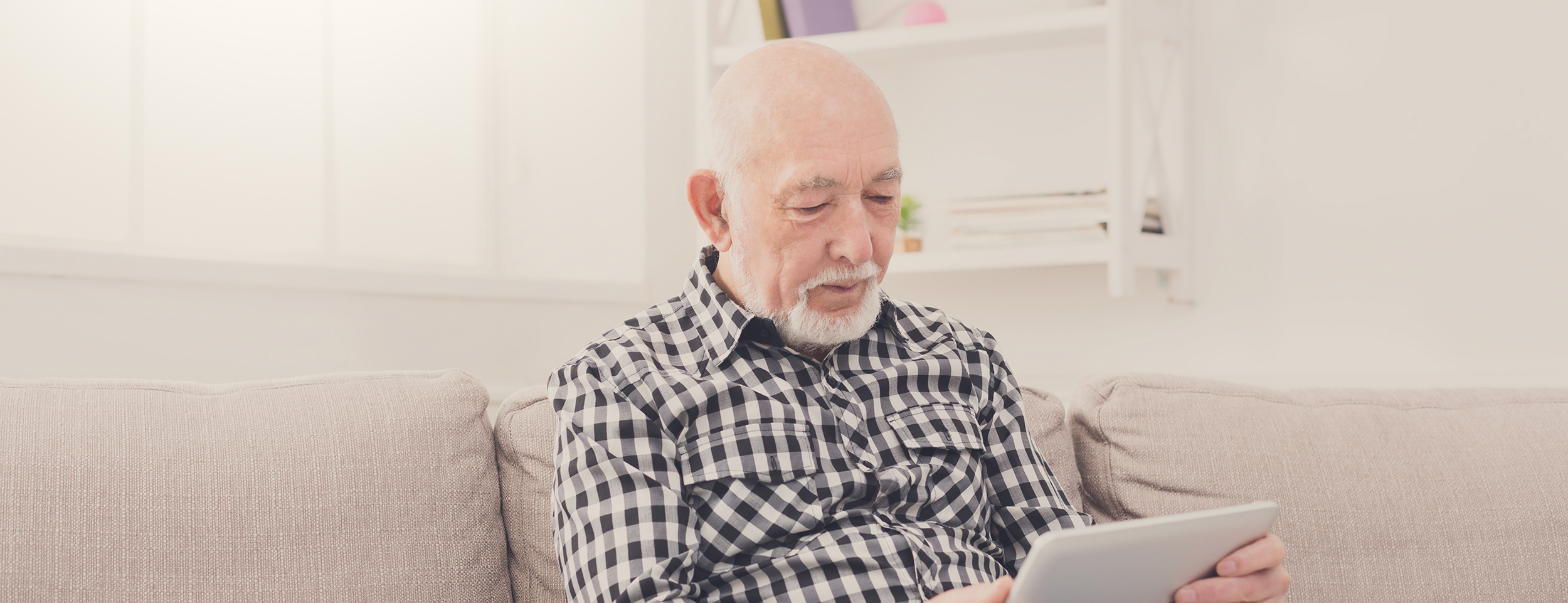Older Man Sitting On Sofa Check Shirt Web